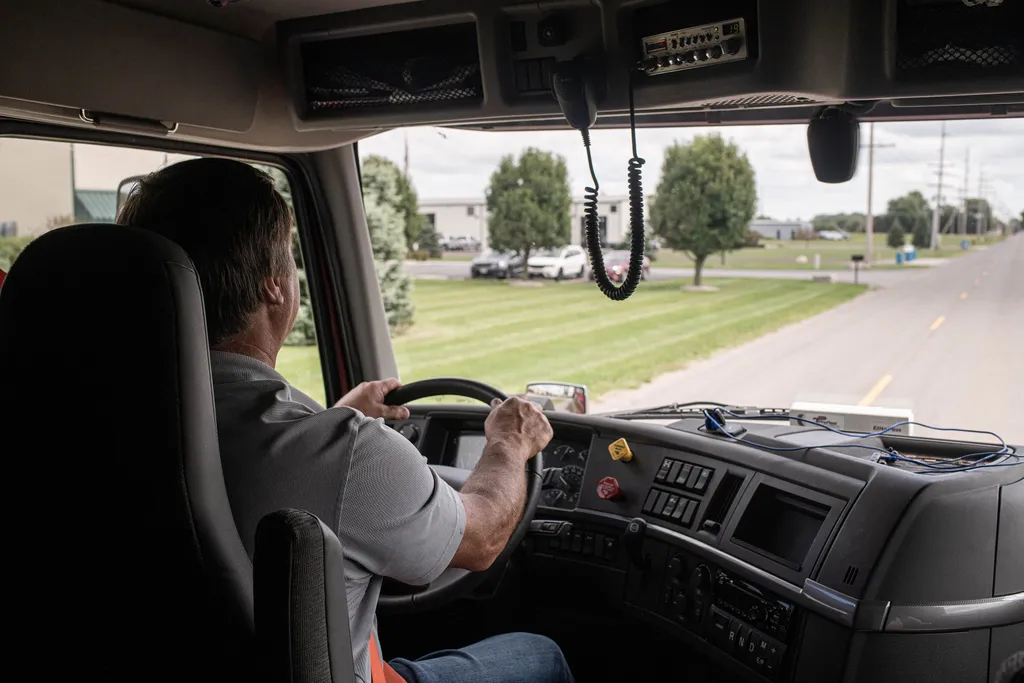 Store & Haul driver climbing into a red semi truck